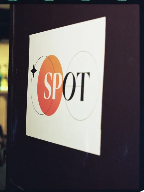 The round Spot sign on the wall by the bar