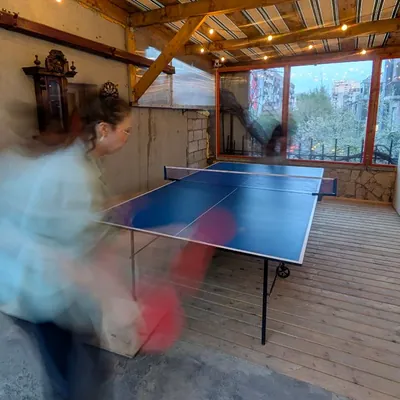 The ping-pong table under the striped awning
